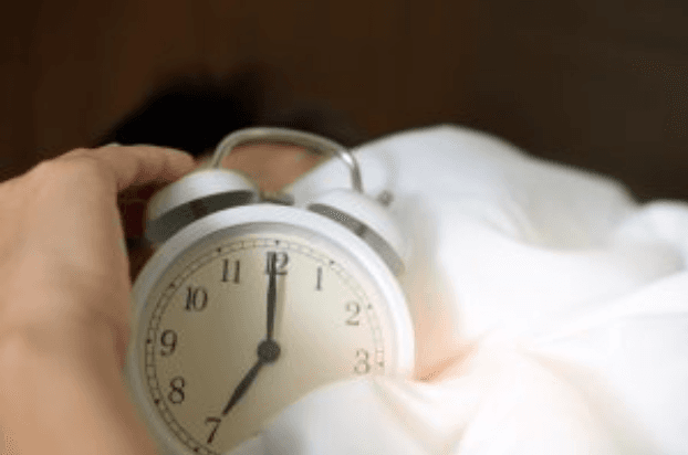 Picture of man hitting top of alarm clock