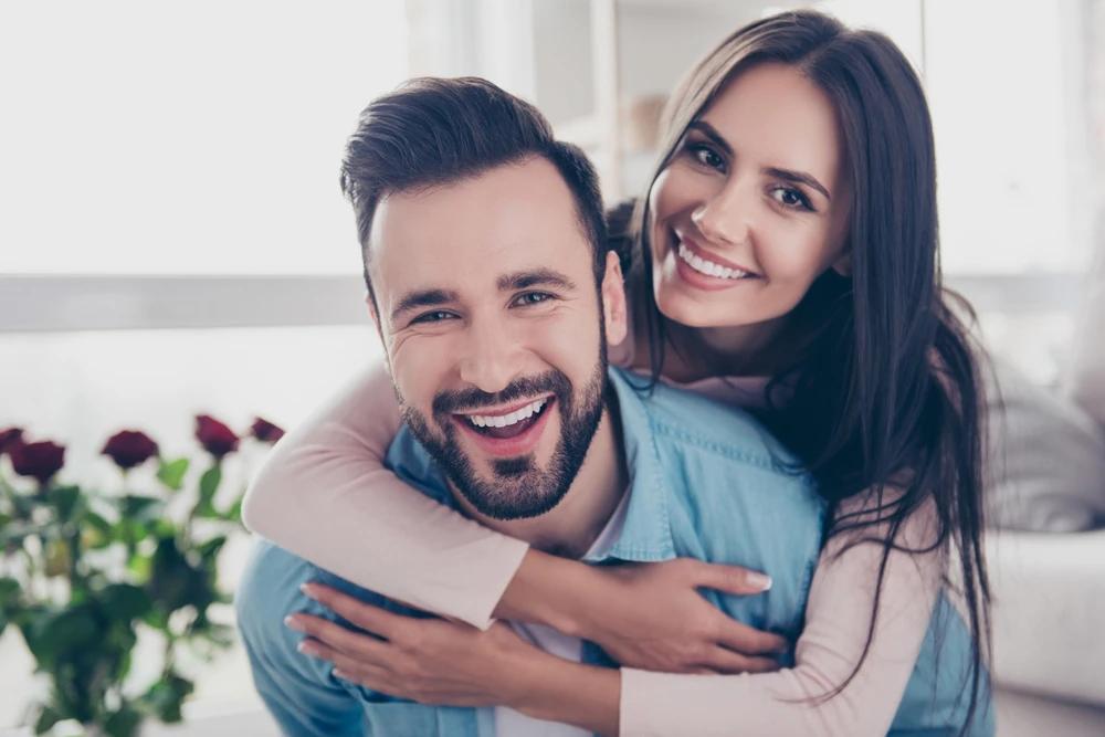 Man and woman smiling and hugging