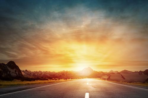 Picture of road with bright sunset in the background