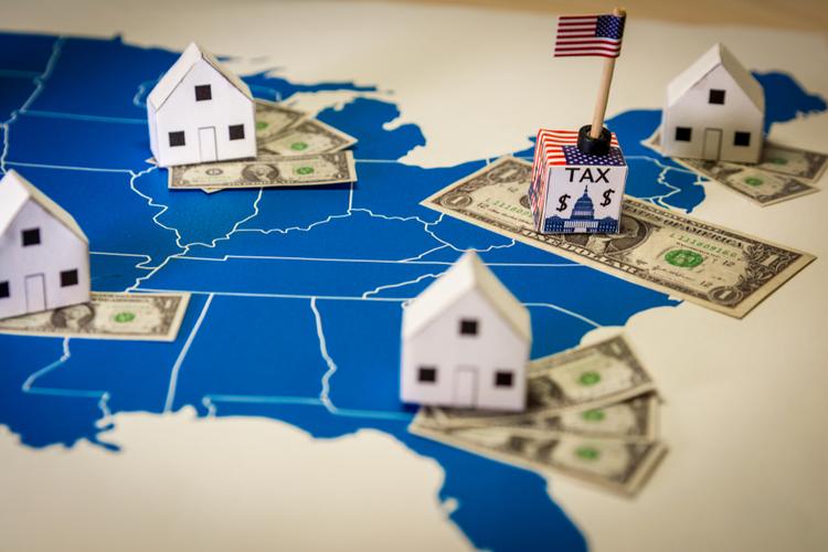Map of US with dollar bills and mini houses on it